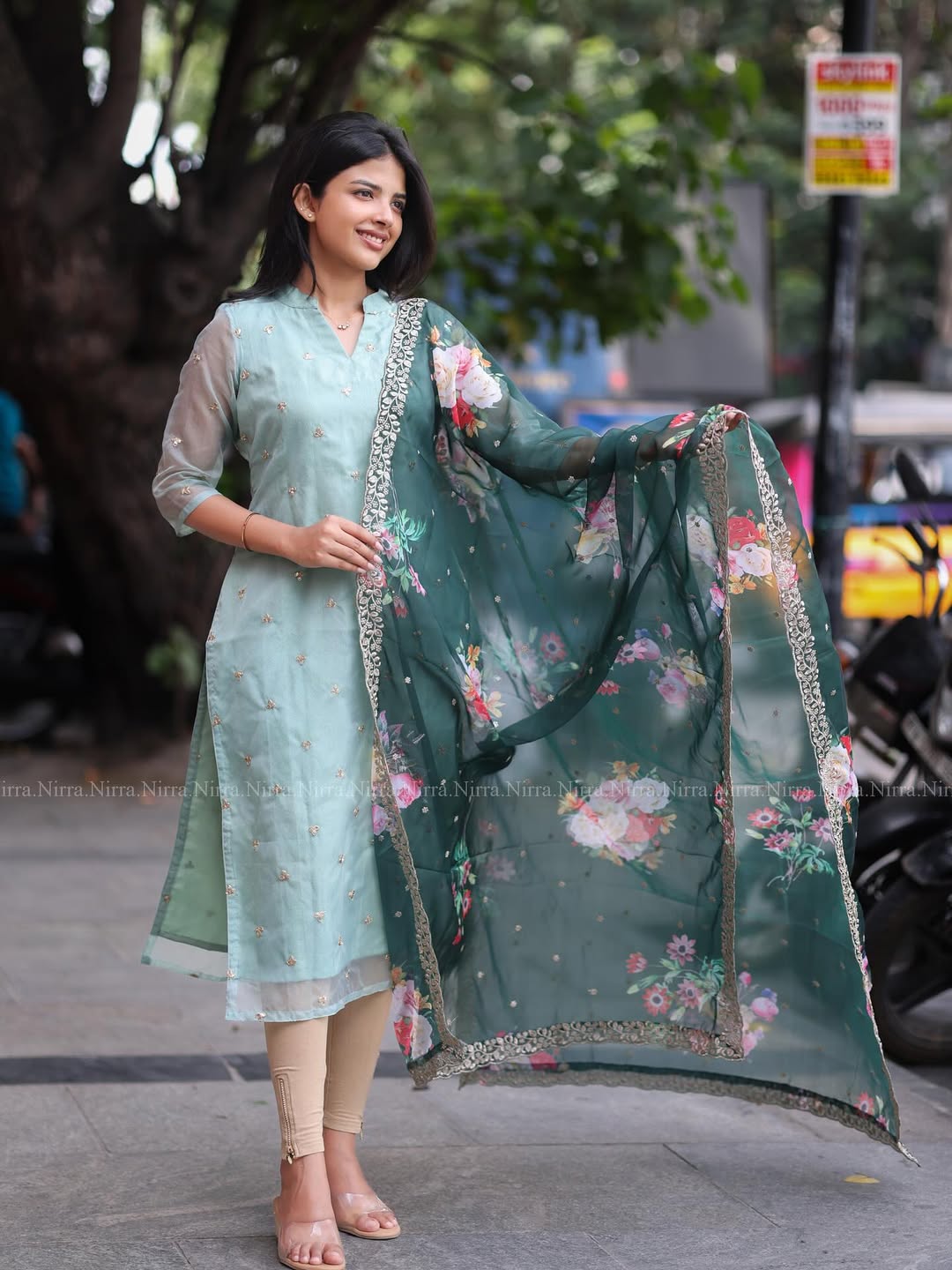 Flaunt in our turquoise green organza top paired with floral shawl salwar set